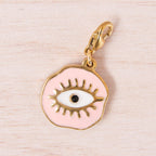 médaille oeil rose doré