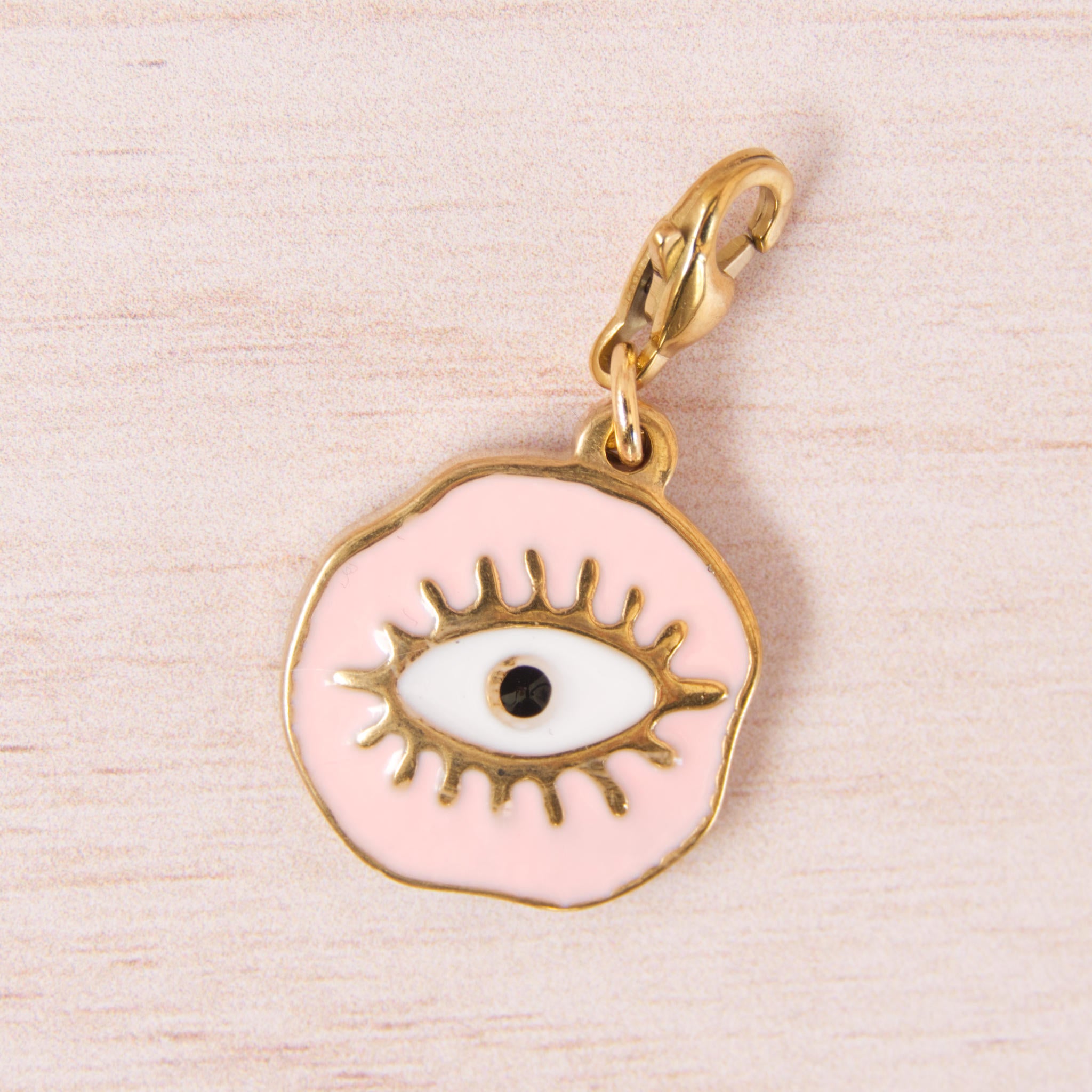 médaille oeil rose doré